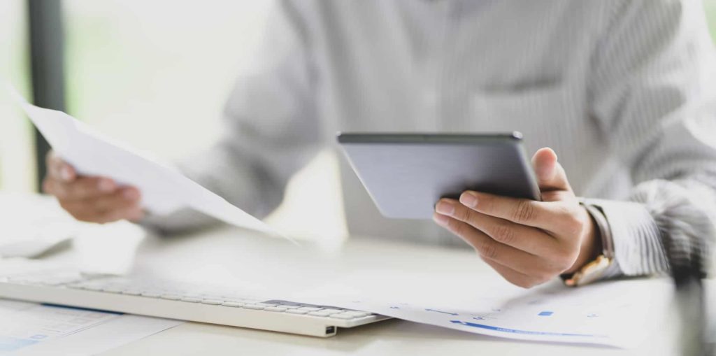 Young businessman working with digital tablet computer ,hands close up